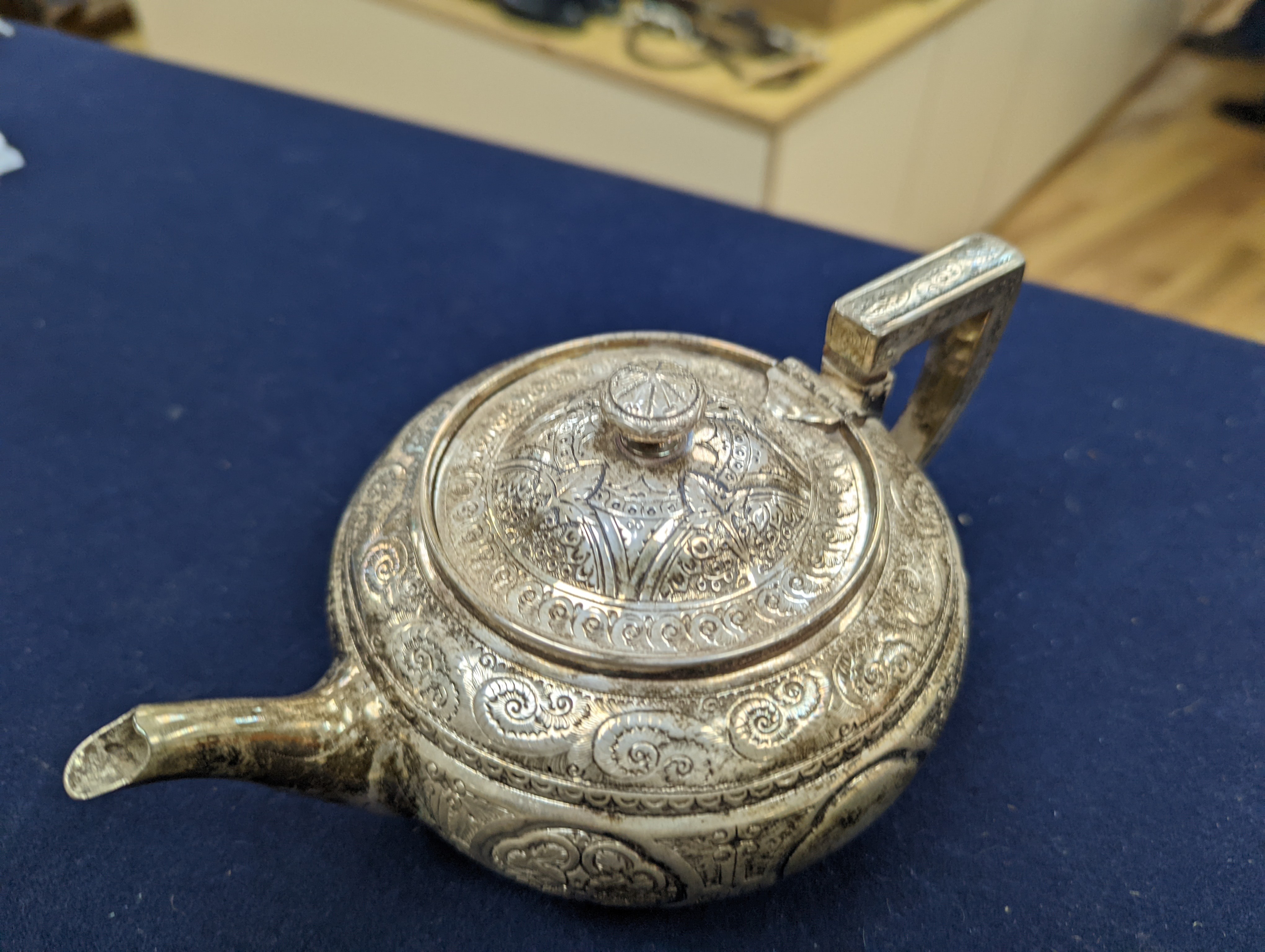 A WMF dish, Islamic white metal mounted photo album and a plated teapot and jug